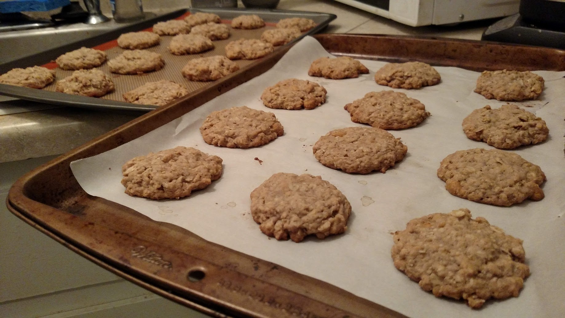 A photograph of a baking tray full of oatmeal butterscotch cookies